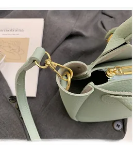Close-up of mint green lychee pattern leather handbag with premium gold hardware and zipper
