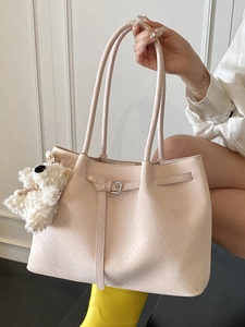 Minimalist textured pink tote bag with adjustable buckle and cute bear charm for women