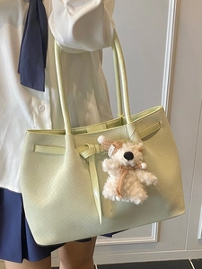 Minimalist light green woven tote bag for women featuring a plush bear pendant on handle
