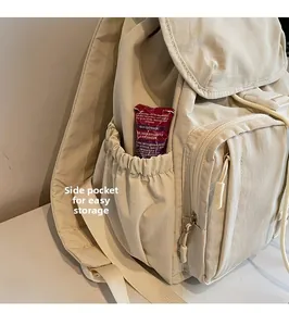 Detail showing beige nylon backpack side pocket with elastic closure for easy storage