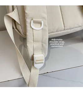 Detail view of the adjustable backpack shoulder strap with a white plastic buckle