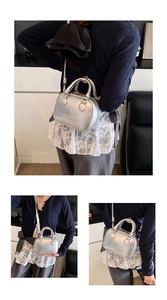 Detail of silver metallic retro bag with embossed retro text and round handles