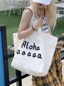 Large white canvas tote bag with black Aloha print for casual summer commute