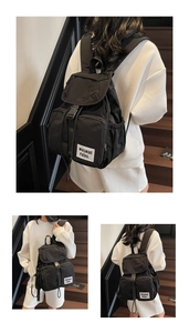 Close-up of lightweight black nylon backpack with multi-pockets and square zip detail