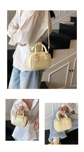 Detail showing the retro capital letter embossing on this pale yellow leather handbag