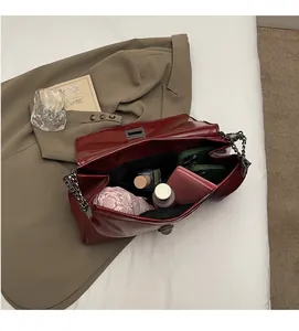 Top view of open red leather tote showing spacious interior with daily essentials