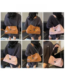 Detailed views of glossy leather tote bag with metal chain strap and twist lock