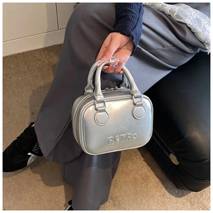 Detail of silver metallic Boston bag with RETRO embossing and round top handles