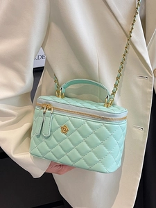Mint green quilted leather vanity bag with gold camellia logo and chain strap