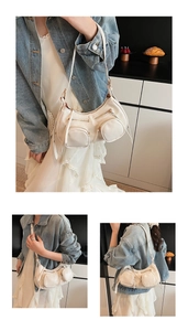 Detail of off-white PU leather hobo bag with dual zipper pockets and punk style hardware