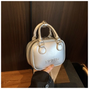 Close-up of the silver metallic leather bag featuring a detailed RETRO embossed design