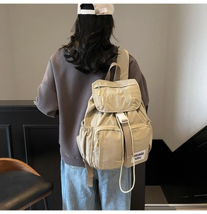 Outdoor khaki backpack detail showing adjustable straps and multiple storage pockets