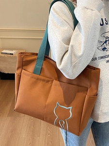 Caramel canvas tote bag with blue straps and cat embroidery for commuting and school use