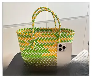 Detail showing tricolor geometric weave texture and sturdy handles of this summer beach bag