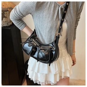 Chic black shiny crescent crossbody bag with multiple zippers and Y2K aesthetic detail