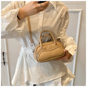Mirror selfie showing the scale and style of the khaki lychee texture mini satchel bag