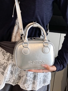 Silver metallic pillow handbag with retro embossed letters and top handles for women