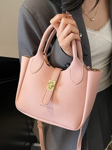Pink litchi grain leather bucket bag with gold hardware and adjustable strap for women