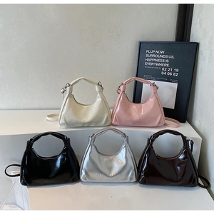 Detailed macro view of oil-wax leather hobo bags in cream, pink, black, silver, and brown