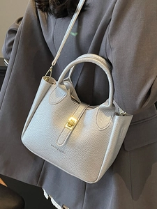 Chic light gray lychee pattern leather bucket bag with gold lock and adjustable strap
