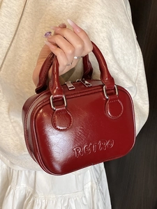 Chic retro wine red glossy leather pillow bag with hand-carried strap and silver zipper