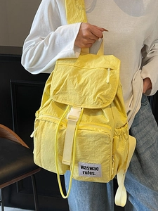 Bright yellow multi-pocket nylon backpack with durable buckles for outdoor travel