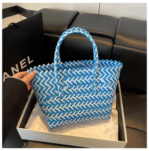 Detail shot of the blue and white V-pattern woven texture on a summer tote bag