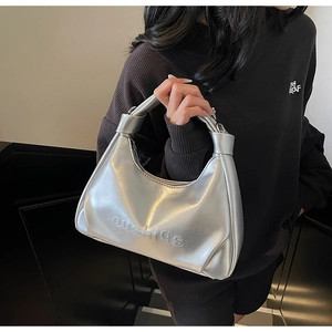 Detail view of silver hobo bag with embossed lettering and metallic oil wax leather texture