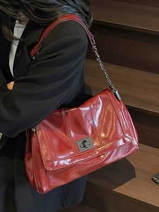Retro wine red tote bag with glossy finish and chain strap for women shown on stairs