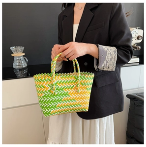 Close-up of tricolor herringbone woven handbag with green and yellow plastic strips