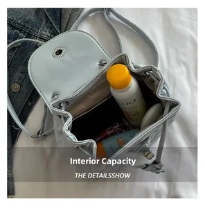 Internal view of mint blue mini backpack showing capacity for sunscreen and cosmetics