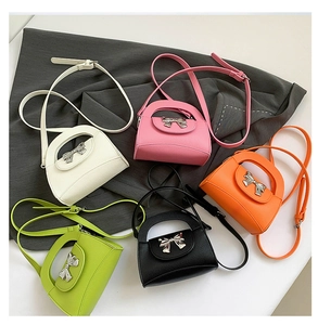 Detailed macro view of retro bow crossbody bags in five vibrant colors with silver buckle
