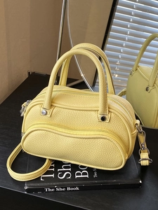 Chic yellow lychee pattern leather bowling bag with silver zipper and shoulder strap