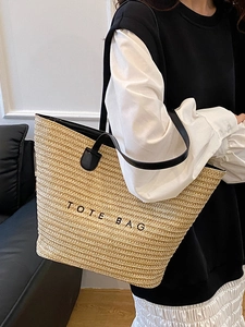 Minimalist straw tote bag with black leather straps and TOTE BAG print for women