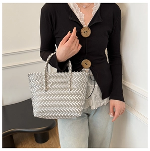 Detail of grey and white V-weave pattern on a chic handmade woven tote bag for summer