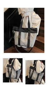 Detail view of a large oxford cloth tote bag with adjustable straps and buckle accents