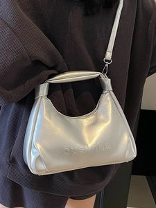 Metallic silver leather handbag with crossbody strap and embossed logo detail