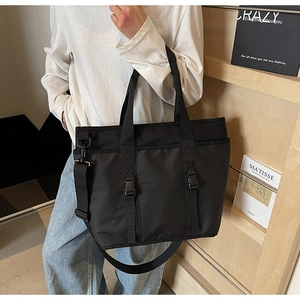 Detail of black large capacity oxford tote bag with adjustable wide strap and buckle strap