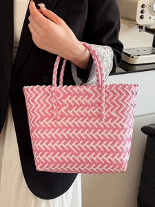 Pink and white woven tote bag with reinforced handles for summer beach vacation