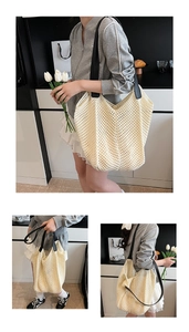 Detail of hollow woven tote bag in cream white with black leather shoulder straps