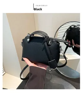 Detailansicht der schwarzen Handtasche aus Leder mit silbernem Reißverschluss und Nieten
