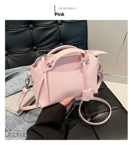Detailansicht der rosa Boston Tasche mit Litschi-Muster Textur und Metall-Zierelementen
