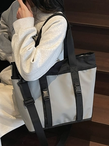 Grey waterproof oxford tote bag with black buckle straps and large capacity for commuting