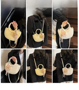 Detail shots of textured crescent bucket bags in creamy white and yellow colors