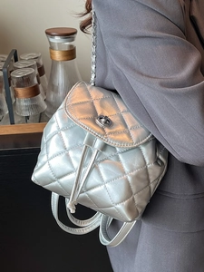 Silver quilted mini backpack with chain strap in elegant metallic finish for women