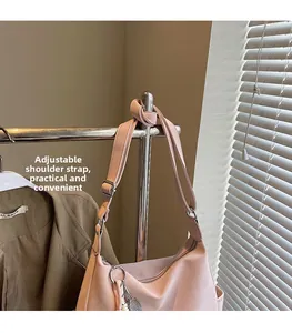 Pink faux leather tote bag detail with adjustable shoulder strap and metal zipper closure