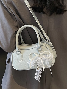 Elegant mint green Boston handbag with lace bow and pearl charm for casual crossbody use