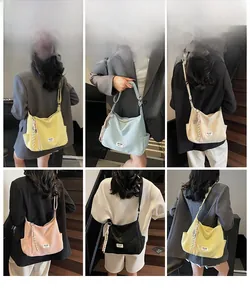 Detail view showing five candy-colored tote bags in yellow, blue, white, pink, and black