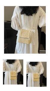 Close-up of handmade straw crossbody bag featuring a white lace bow and woven texture