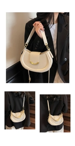 Detail view of lychee texture cream crescent saddle bag with gold metal hardware buckle